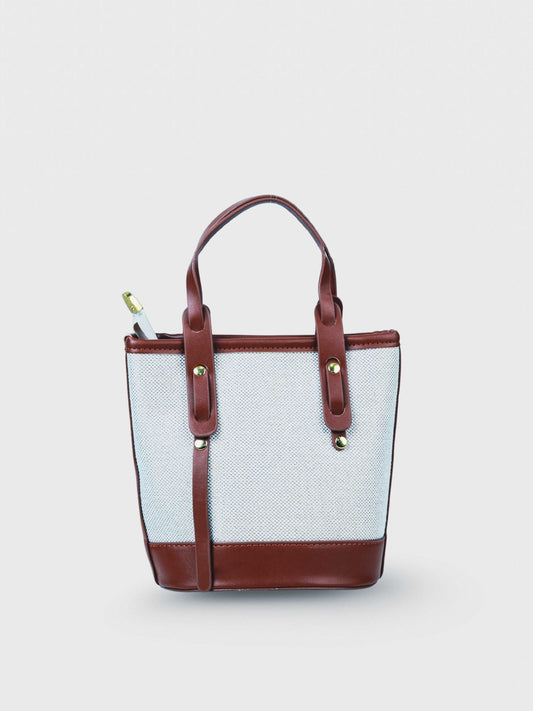 Marais Vanilla Haze vegan leather crossbody bag in warm cream tones with structured bucket shape and adjustable strap for women.
