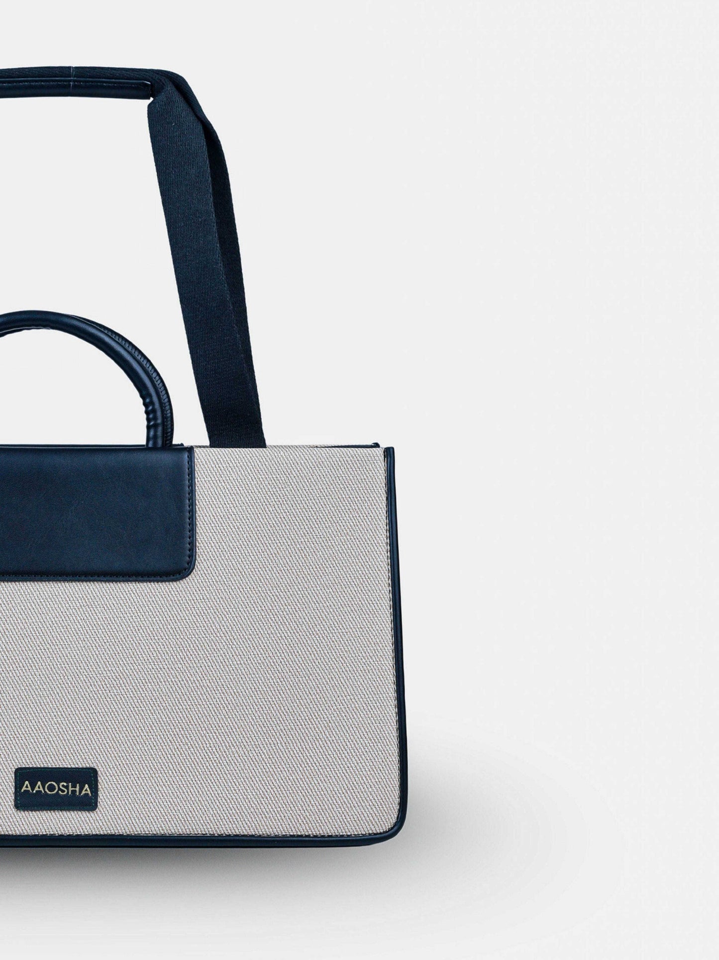 Florence Ivory Noir vegan leather tote bag in off white and black tones with structured design and dual handles for women.