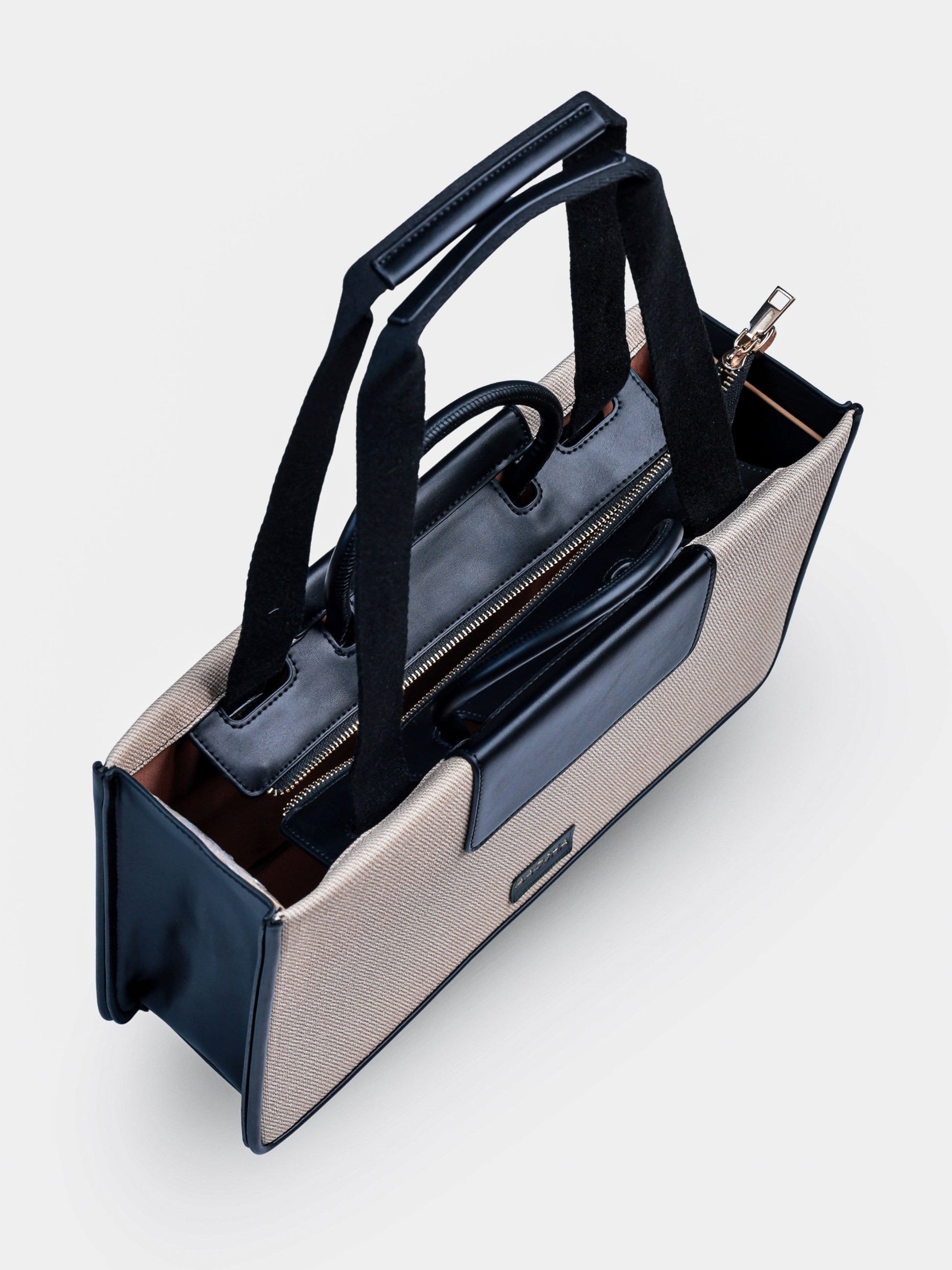 Florence Ivory Noir vegan leather tote bag in off white and black tones with structured design and dual handles for women.