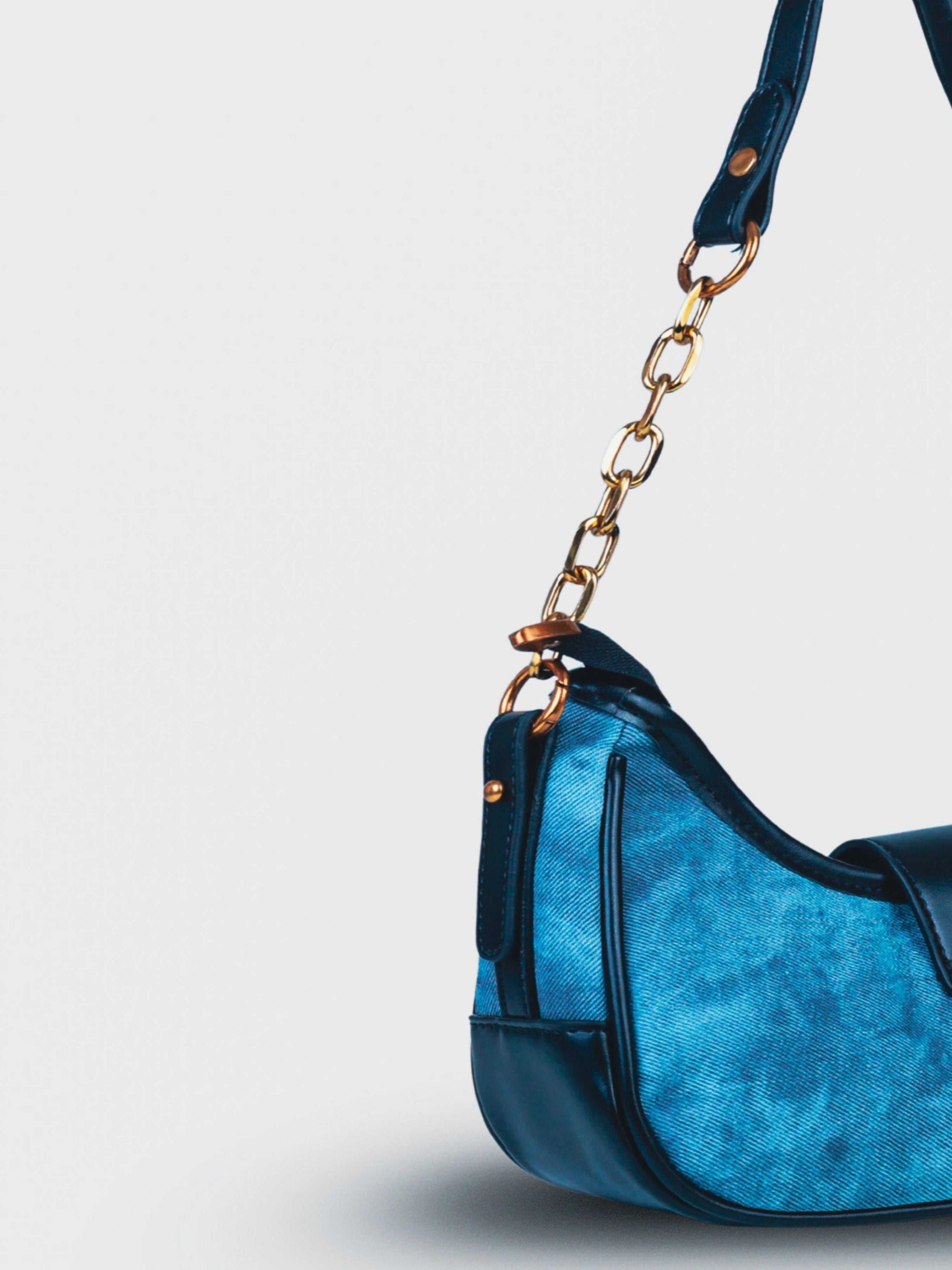 Luna Denim Blue vegan leather shoulder bag in rich blue denim with structured design and chain handle for women.