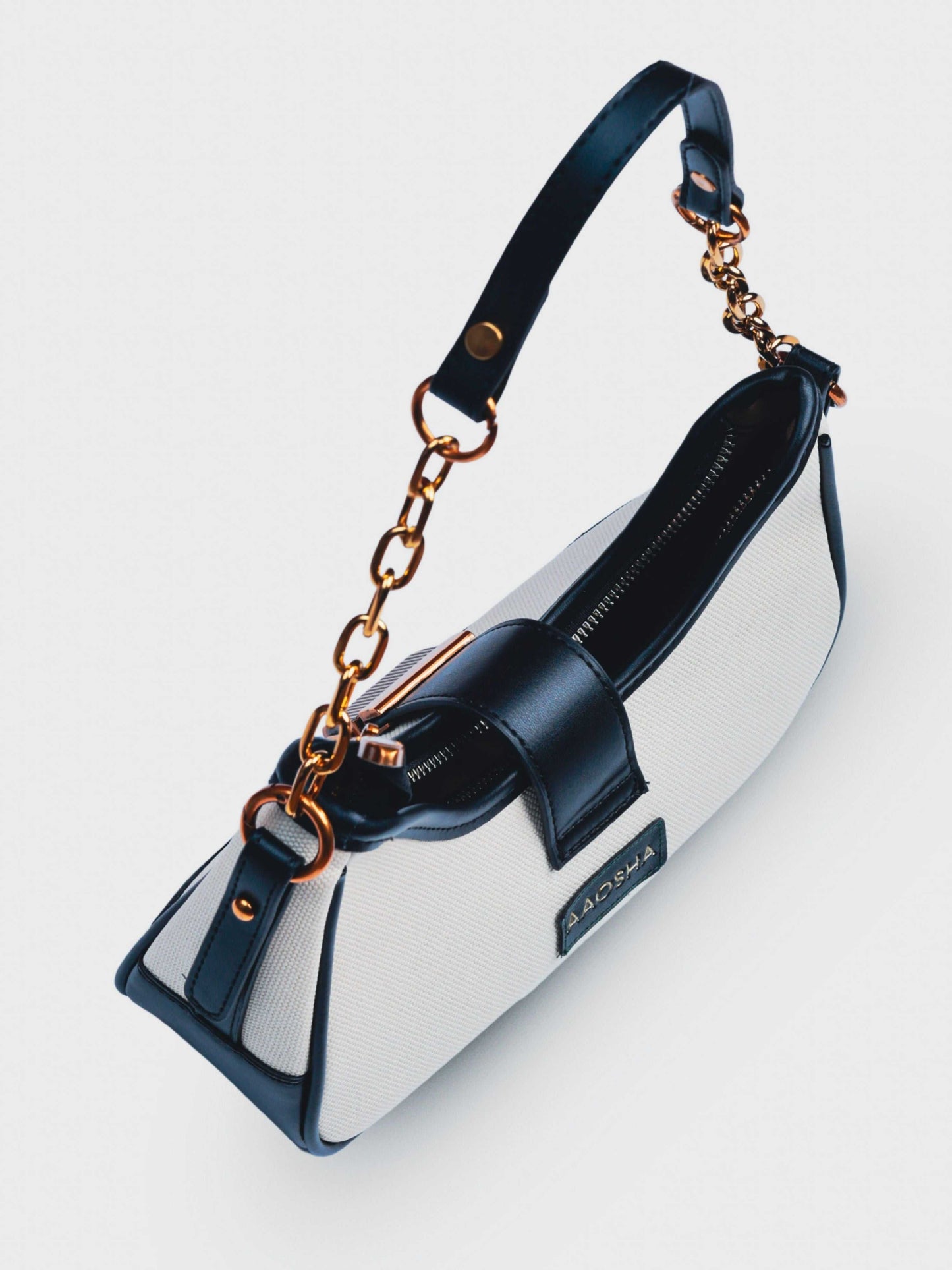 Luna Ivory Noir vegan leather shoulder bag in cream and black tones with structured design and chain handle for women.