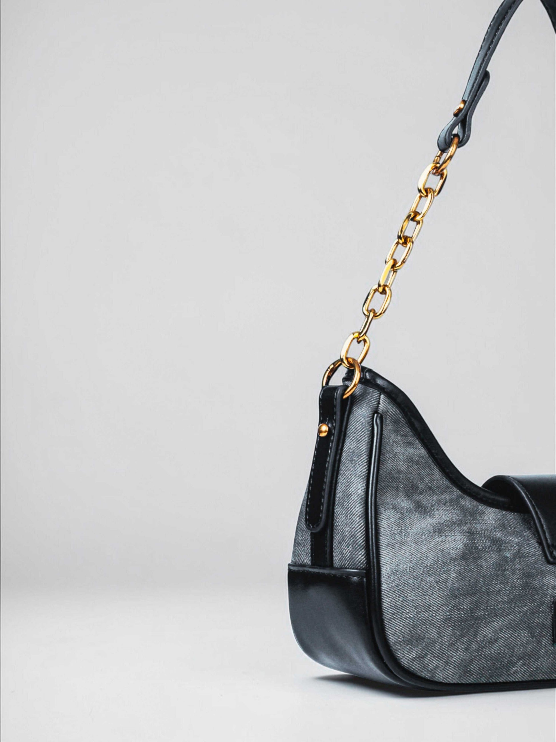Luna Midnight vegan leather shoulder bag in black denim with structured silhouette and chain handles for women.
