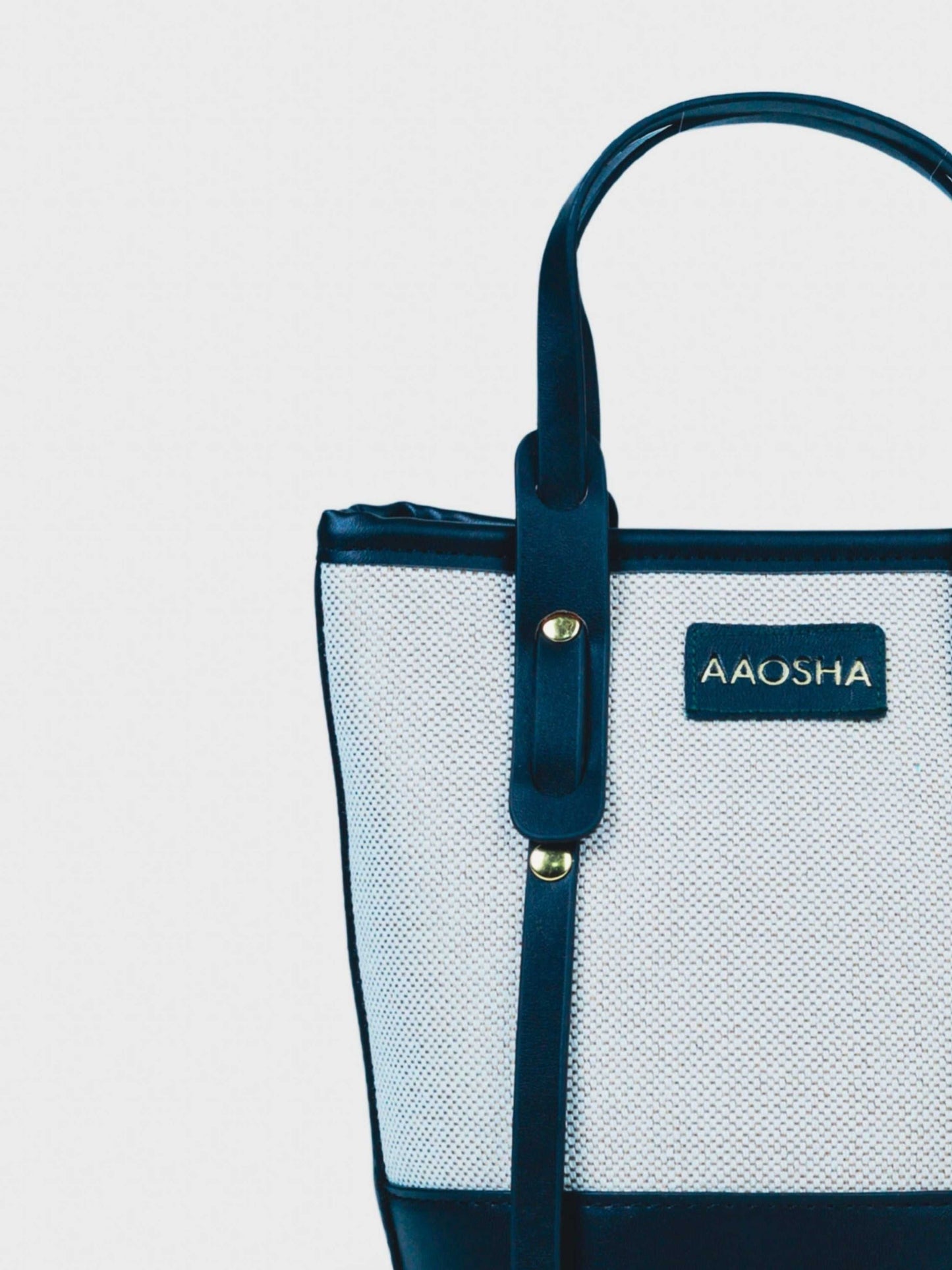Marais Ivory Noir vegan leather crossbody bag featuring cream and black tones with structured bucket shape and adjustable strap for women.