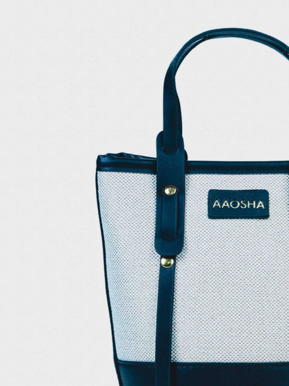 Marais Ivory Noir vegan leather crossbody bag featuring cream and black tones with structured bucket shape and adjustable strap for women.