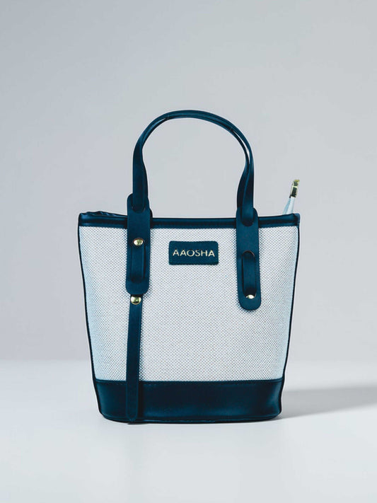 Marais Ivory Noir vegan leather crossbody bag featuring cream and black tones with structured bucket shape and adjustable strap for women.