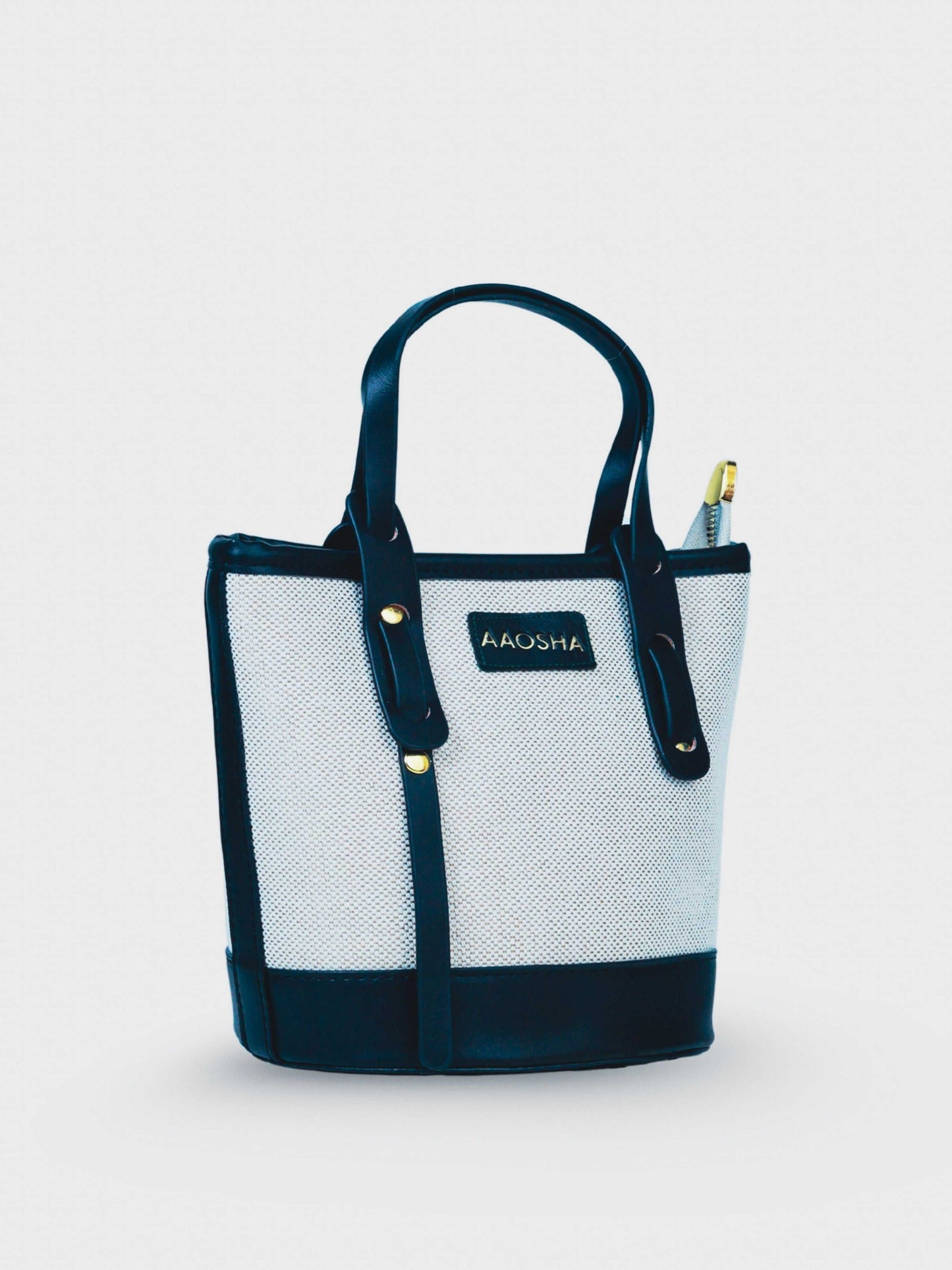 Marais Ivory Noir vegan leather crossbody bag featuring cream and black tones with structured bucket shape and adjustable strap for women.