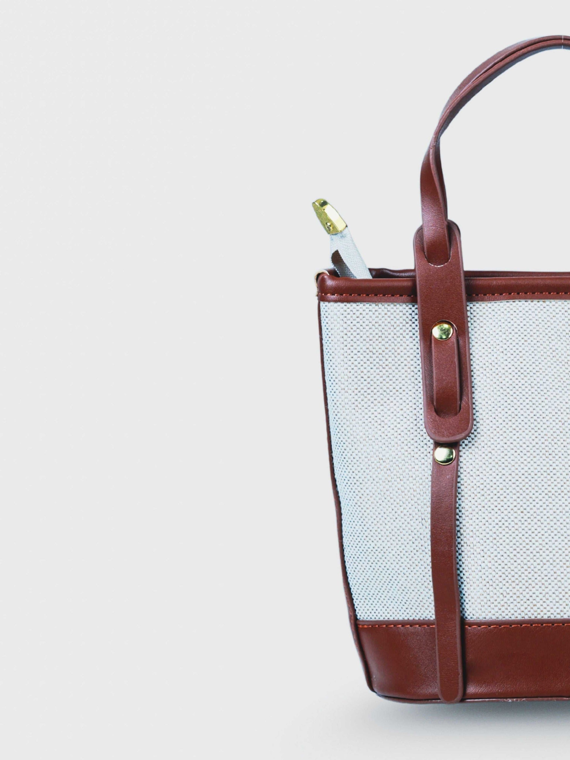 Marais Vanilla Haze vegan leather crossbody bag in warm cream tones with structured bucket shape and adjustable strap for women.