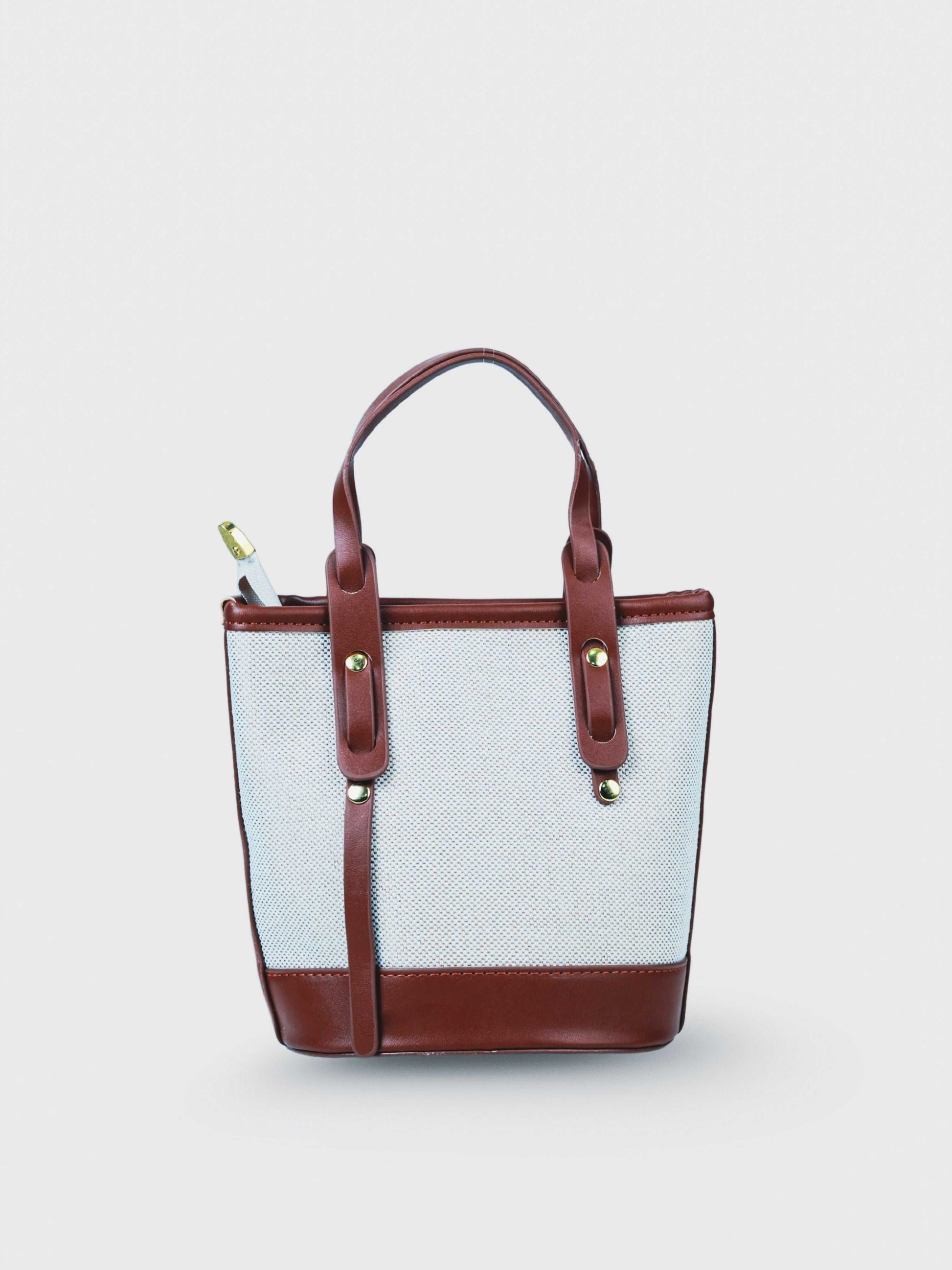 Marais Vanilla Haze vegan leather crossbody bag in warm cream tones with structured bucket shape and adjustable strap for women.