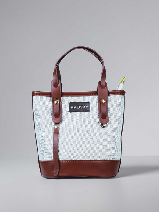 Marais Vanilla Haze vegan leather crossbody bag in warm cream tones with structured bucket shape and adjustable strap for women.