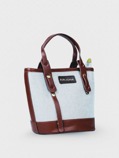 Marais Vanilla Haze vegan leather crossbody bag in warm cream tones with structured bucket shape and adjustable strap for women.