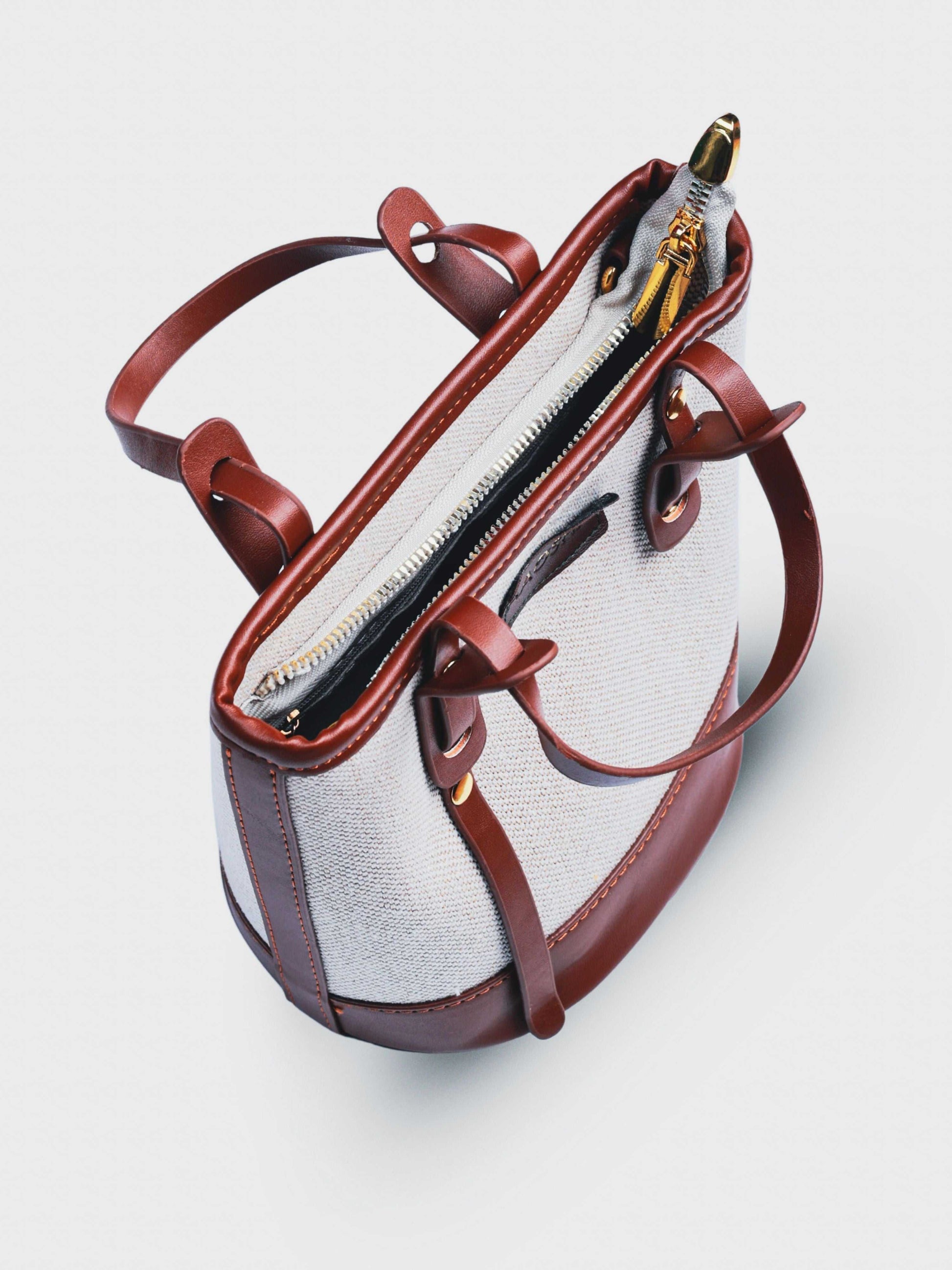 Marais Vanilla Haze vegan leather crossbody bag in warm cream tones with structured bucket shape and adjustable strap for women.