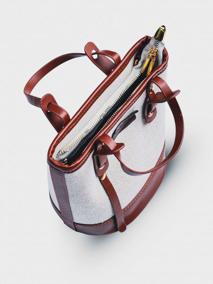 Marais Vanilla Haze vegan leather crossbody bag in warm cream tones with structured bucket shape and adjustable strap for women.