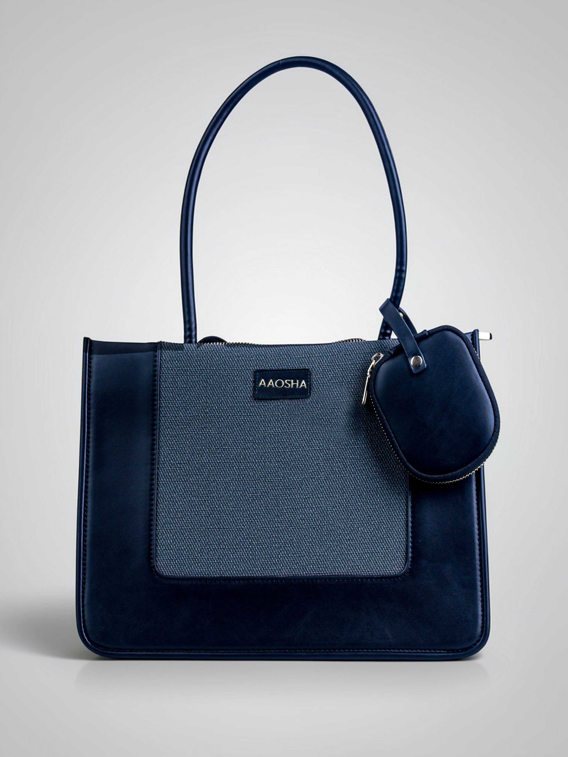 Valencia Eternal Ink vegan leather shoulder bag in pure black with structured silhouette and dual handles for women.