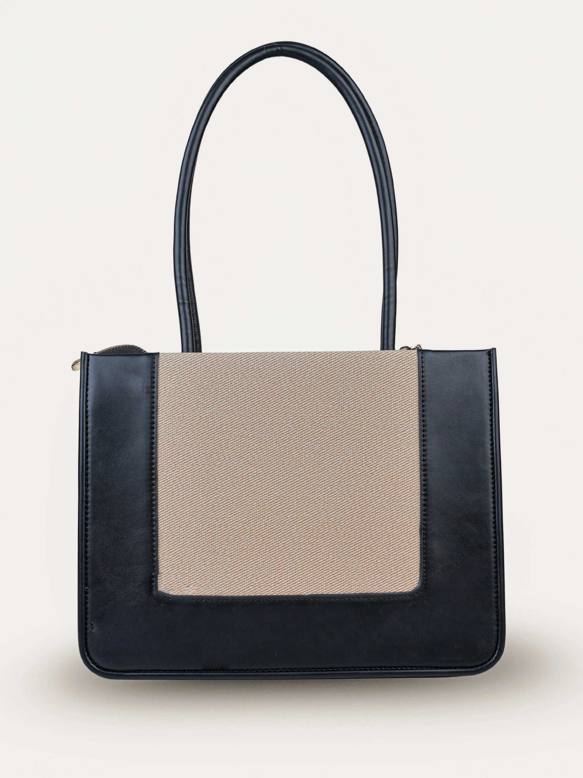 Valencia Ivory Noir vegan leather shoulder bag in cream and black tones with structured design and dual handles for women.