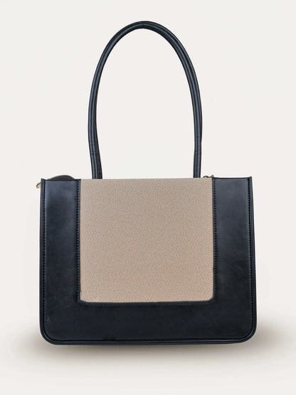 Valencia Ivory Noir vegan leather shoulder bag in cream and black tones with structured design and dual handles for women.