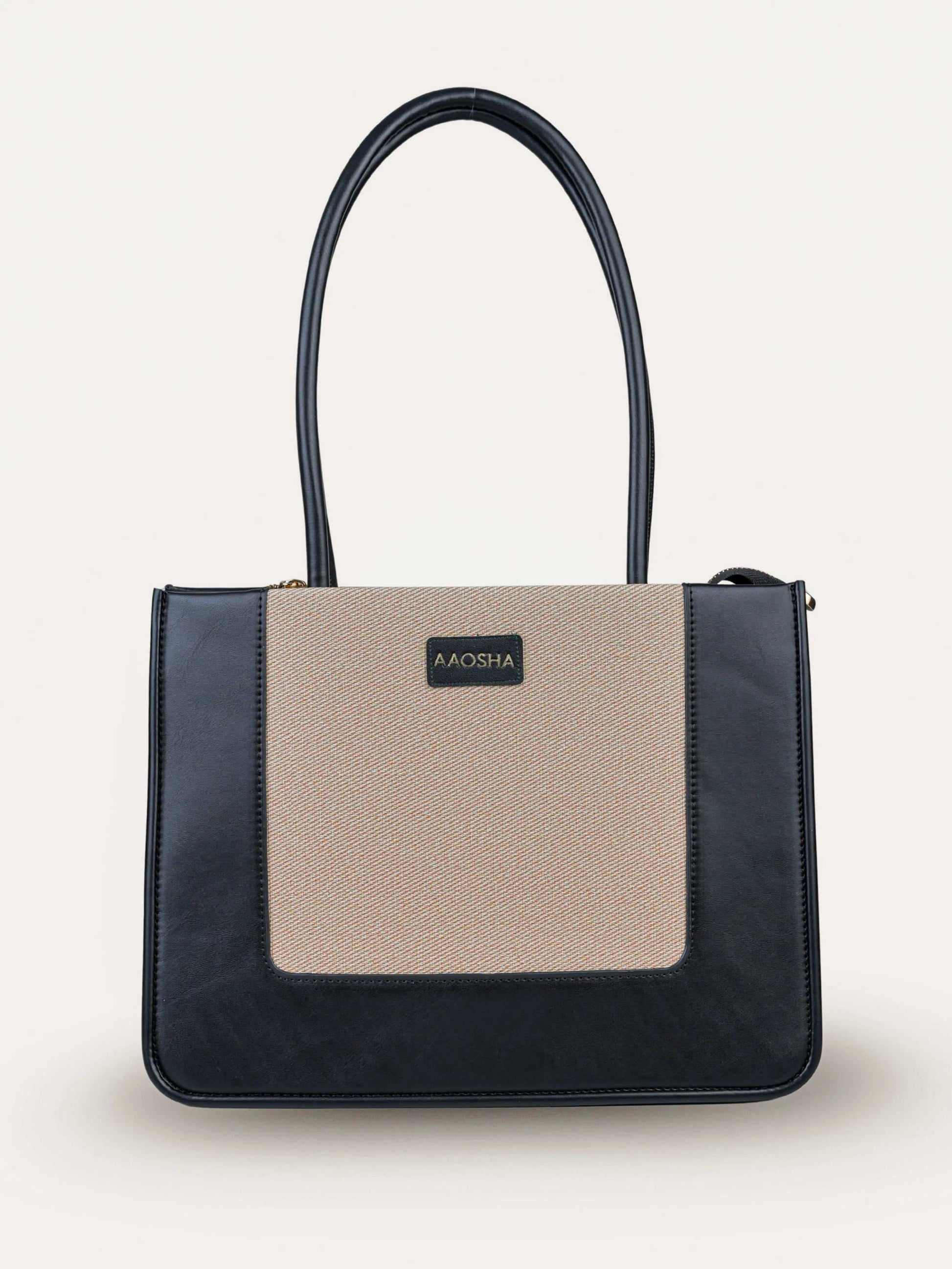 Valencia Ivory Noir vegan leather shoulder bag in cream and black tones with structured design and dual handles for women.