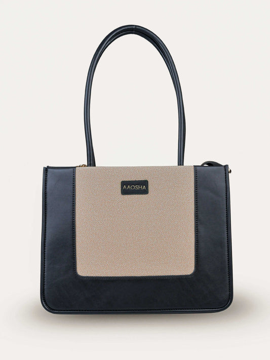 Valencia Ivory Noir vegan leather shoulder bag in cream and black tones with structured design and dual handles for women.