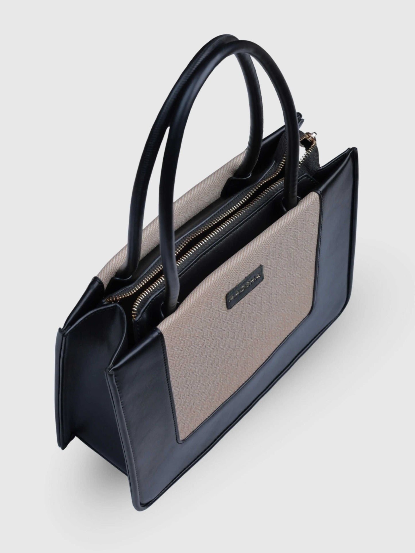 Valencia Ivory Noir vegan leather shoulder bag in cream and black tones with structured design and dual handles for women.